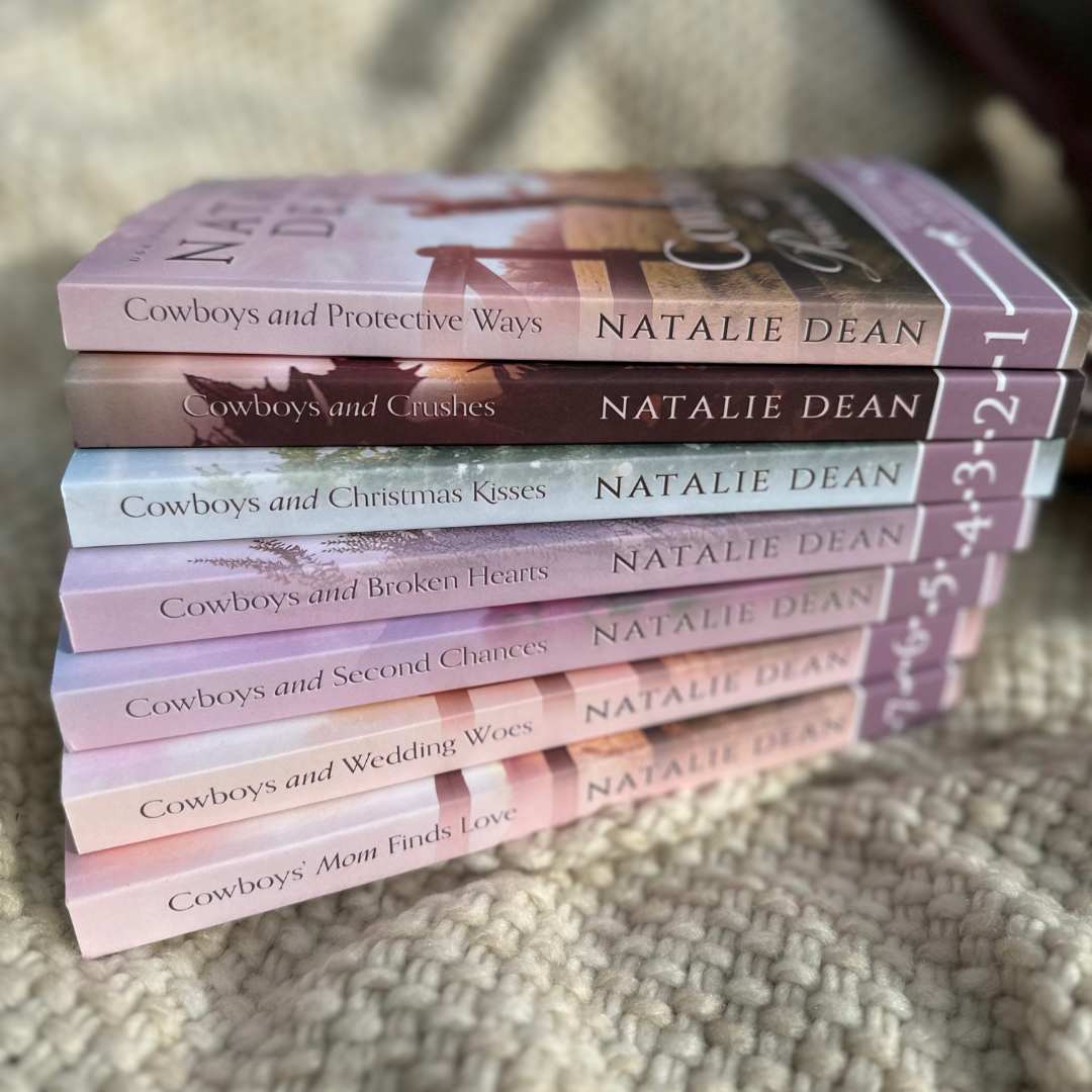 Stack of Baker Brothers of Copper Creek books in paperback format. Sitting on pretty blanket. Sweet Western Romance Books